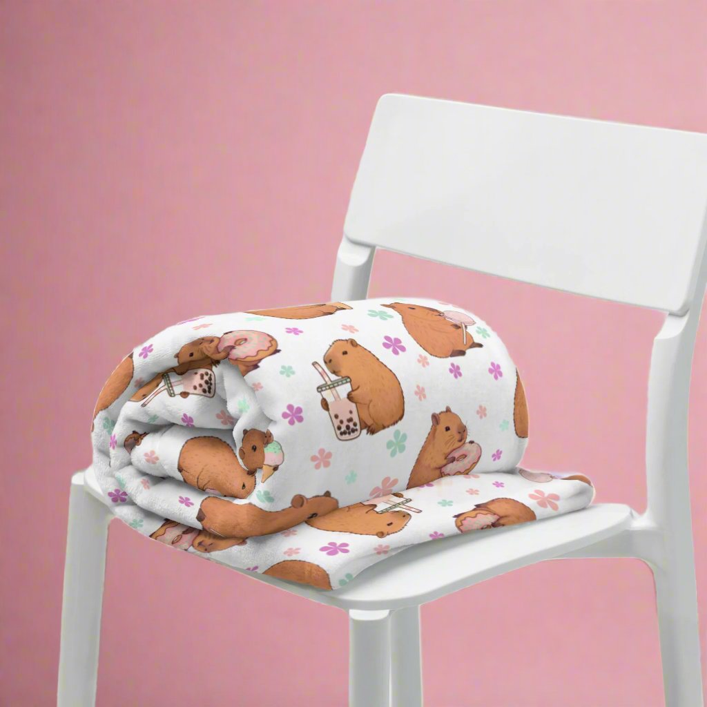 Sweets Loving Capybara Cozy Velveteen Plush Blanket on chair