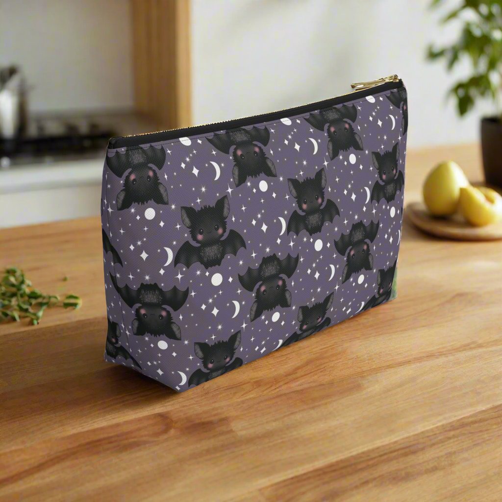 Angled view of Large Cute Bats, Moon and Stars Accessory Pouch with T-bottom on wood kitchen counter