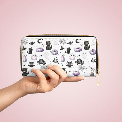 Cute Halloween Zipper Wallet with Black Cats, Ghosts, Bats and Spiders in someone's hand
