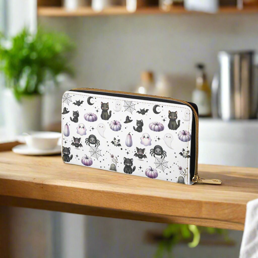 Cute Halloween Zipper Wallet with Black Cats, Ghosts, Bats and Spiders on kitchen counter