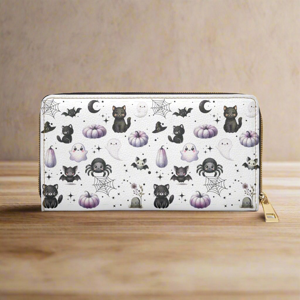 Cute Halloween Zipper Wallet with Black Cats, Ghosts, Bats and Spiders on wood table