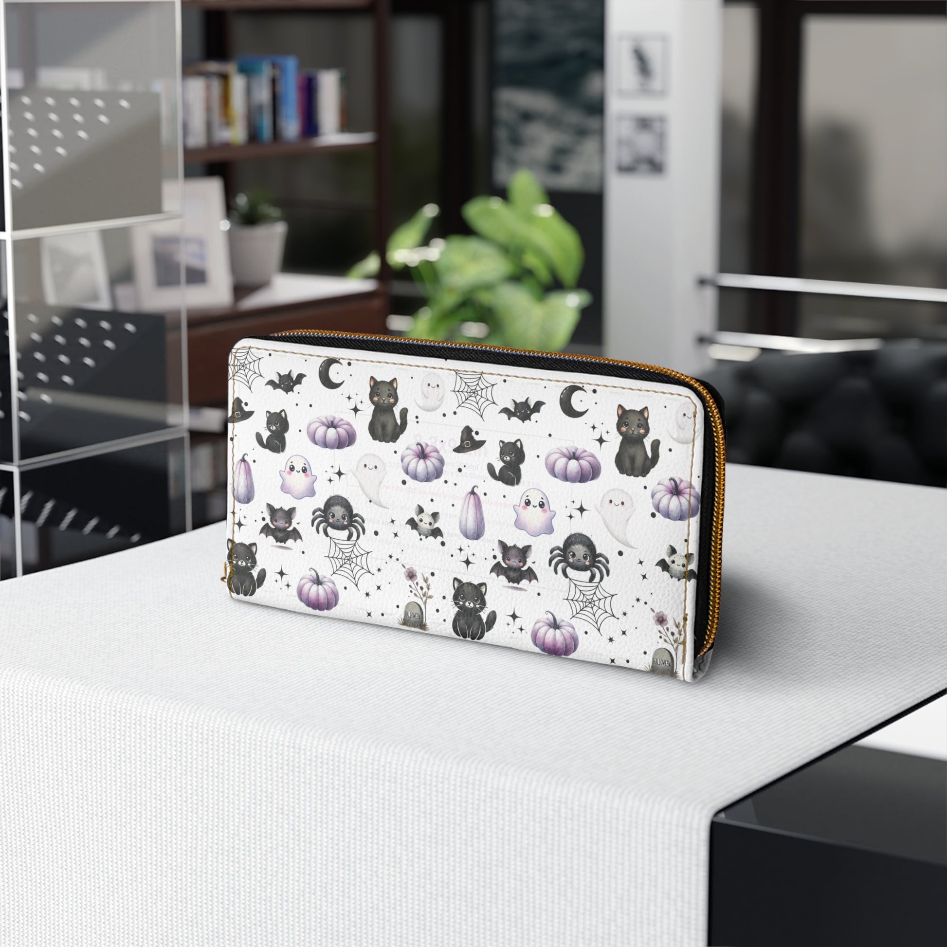 Cute Halloween Zipper Wallet with Black Cats, Ghosts, Bats and Spiders on table