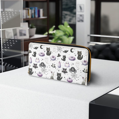 Cute Halloween Zipper Wallet with Black Cats, Ghosts, Bats and Spiders on table