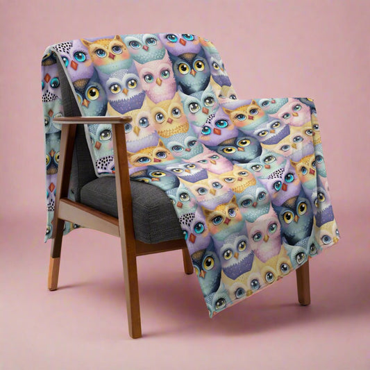 Pastel Parliament of Owls Cozy Velveteen Plush Blanket on a chair