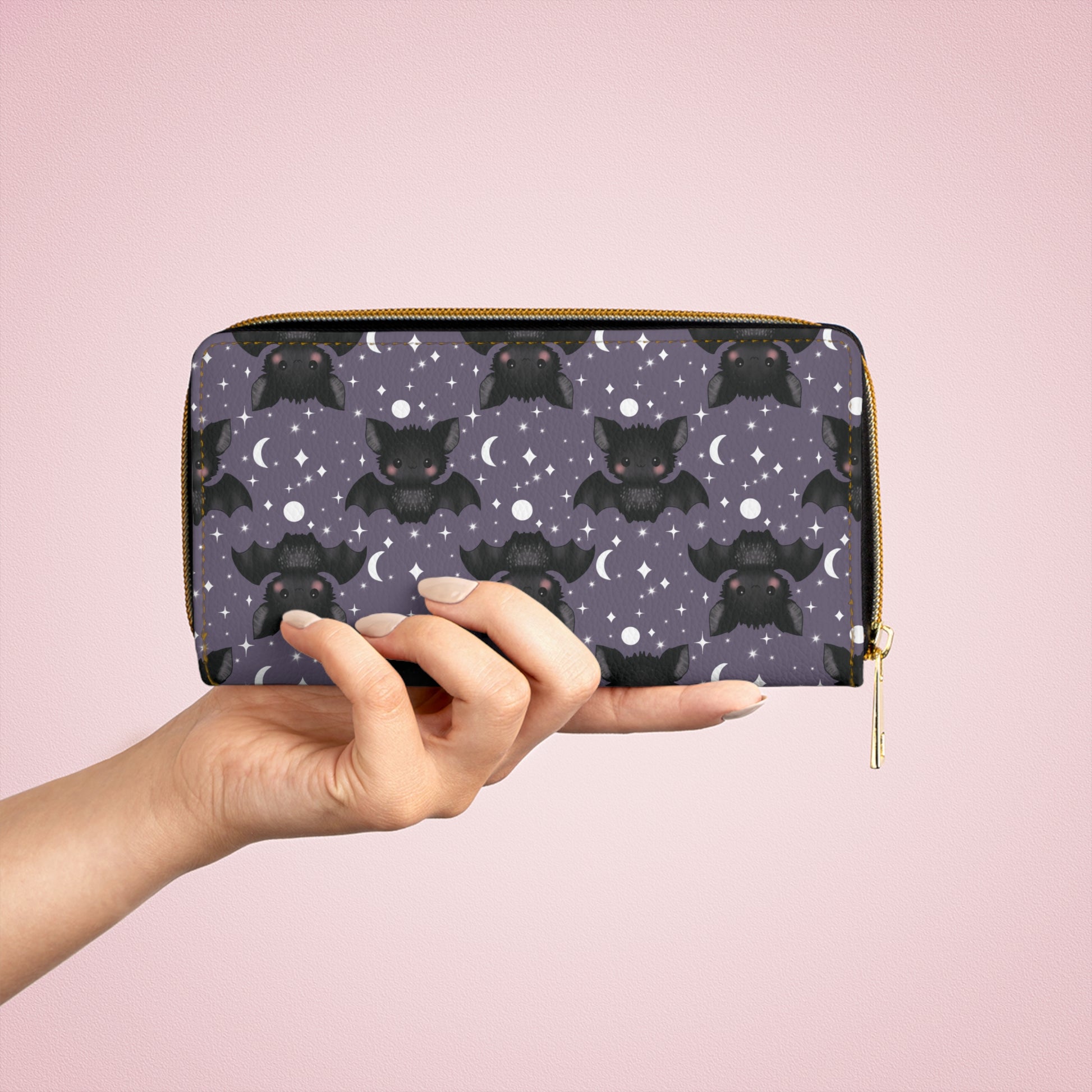 hand holding Purple Zipper Wallet with Cute Bats & Stars