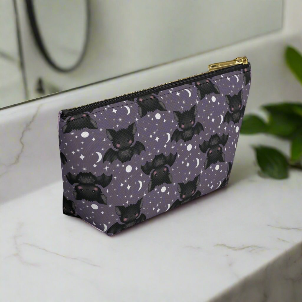 side view of smallCute Bats, Moon and Stars Accessory Pouch with T-bottom on bathroom counter