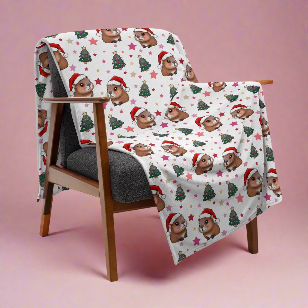 Cute Christmas Capybaras Cozy Velveteen Plush Blanket 60x80 inches draped over chair