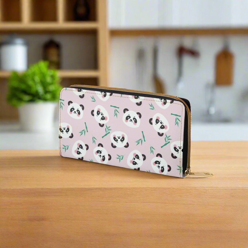 pink women's wallet with cute panda faces on kitchen counter